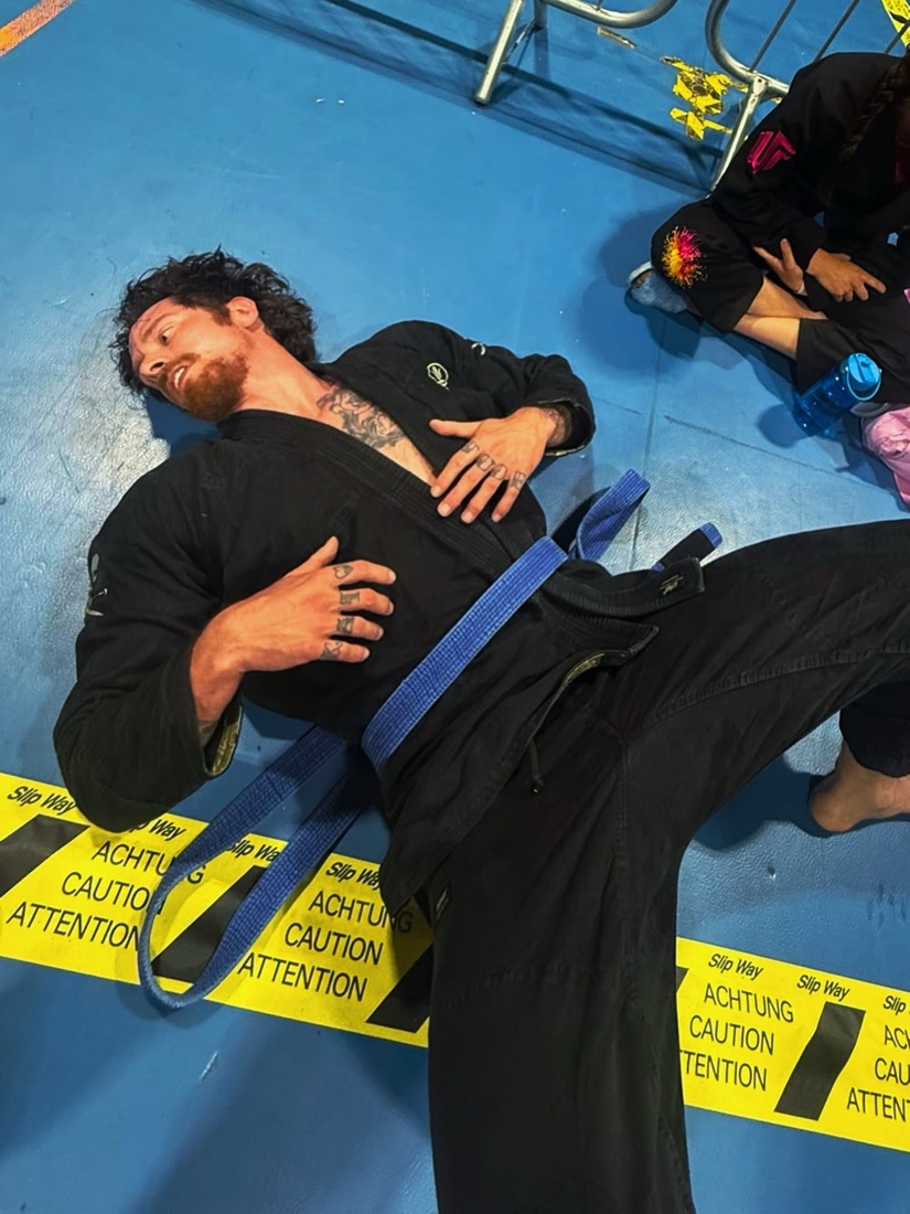 Ollie on the mats in his gi and blue belt